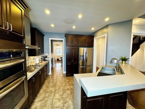 Deluxe House, 4 Bedrooms, Patio, Garden View | Private kitchen | Coffee/tea maker, electric kettle, toaster, highchair - Spacious 4-Bedroom Retreat (Brampton)