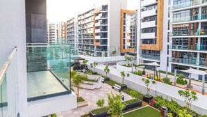 A modern hotel with multiple floors, outdoor terraces with seating, and a pool area. - Bloomfields STU Balcony Azizi Riviera Meydan (Dubai)