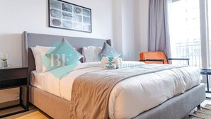 A hotel room with a bed, a nightstand, a framed artwork on the wall, and a window with curtains. - Bloomfields Stylish STU in Waters Edge Yas Island (Abu Dabi)