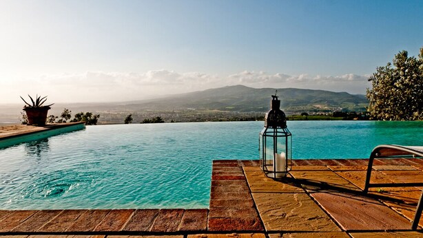 A clear view of a swimming pool with a wooden deck, a lantern, and a potted plant. - Cottage - The Hill Below - Imagine a place just for you (Toscana)