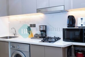 Fridge, microwave, stovetop, coffee/tea maker