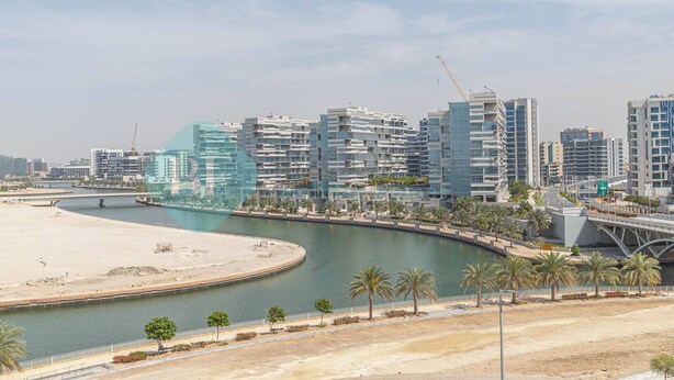 A coastal cityscape with modern high-rise buildings, a marina, and a sandy beach. - Bloomfields Spacious STU in Thalassa Beach Front (Abu Dabi)