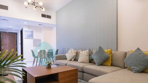 A modern living room with a sofa, coffee table, and decorative pillows.
