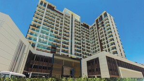 A high-rise building with multiple balconies and a modern architectural design. - Bloomfields Hidden Gem Studio In Arjan (Dubai)
