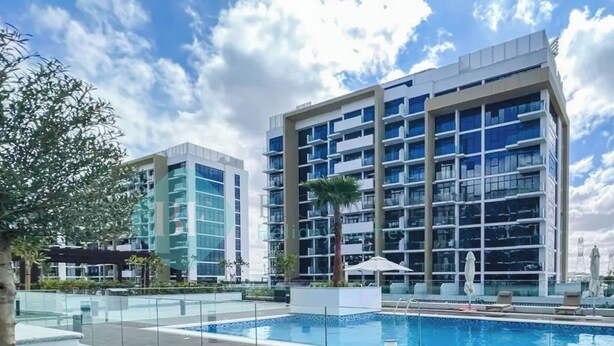 A modern hotel with a swimming pool, multiple floors, and a clear sky. - Bloomfields Fantastic STU Azizi Riviera Meydan (Dubai)