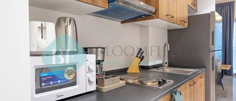 Fridge, microwave, stovetop, coffee/tea maker