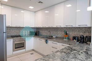 Fridge, microwave, oven, stovetop - Bloomfields Cozy 1BR In JVC - Regent Court (Dubai)