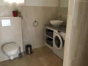 Shower, hair dryer, towels, toilet paper
