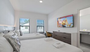A hotel room with two beds, a desk, a chair, a TV, and a bathroom. - The Epic 10406 Paradiso Grande Resort Orlando Florida (Orlando)