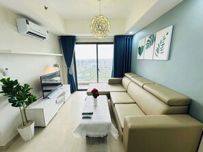 Luxury Apartment, City View | Living area | 60-inch flat-screen TV with cable channels - Masteri Thao Dien Apartment  (Ho Chi Minh City)