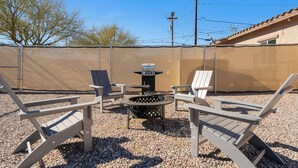 A fenced outdoor area with Adirondack chairs and a fire pit. - A-Mountain Wonder! HUGE yard, dogs OK - Brand New everything Close to Downtown! (Tucson)