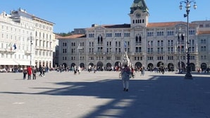 A large public square with historic buildings, including a prominent clock tower. - Trieste Central Holiday Home (Trieste)