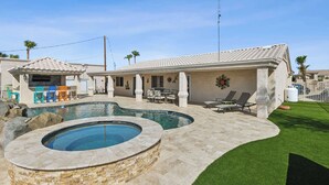 A residential property with a swimming pool, outdoor seating, and a well-maintained lawn. - Havasu Hacienda Private Pool! (Lake Havasu City)