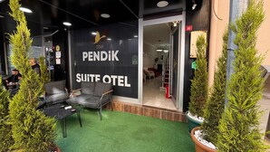 A modern hotel entrance with a black facade, a sign reading "PENDIK SUITE HOTEL," and a reception area visible through the doorway. - PENDİK SUİT OTEL (Istanbul)