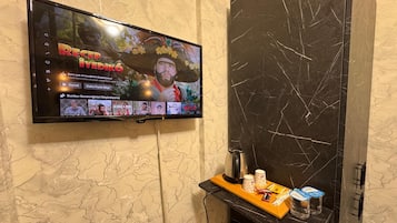 Economy Room, City View | Living area | 32-inch Smart TV with satellite channels