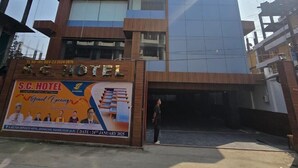 A multi-story hotel with a modern design, featuring a prominent entrance and a large signboard advertising a grand opening. - SC Hotel (Papumpare)