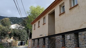 A building with a stone base and a beige upper section, labeled "San Bonifacio." - Gite d'étape Benjamin sur le sentier Cathare (3-person room) (Prugnanes)