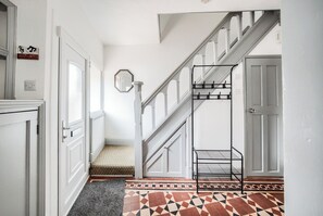 Staircase leads to an upper level with a geometric patterned floor.