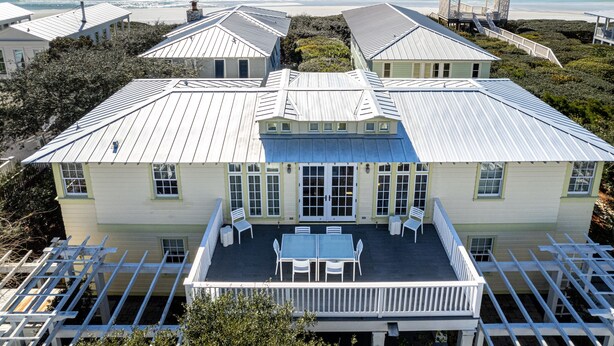 A large house with a covered patio, white railings, and a view of the ocean. - Beachside in Seaside, FL, 3 King Suites, Amazing Gulf Views - 2 Adult Bikes! (Santa Rosa Beach)