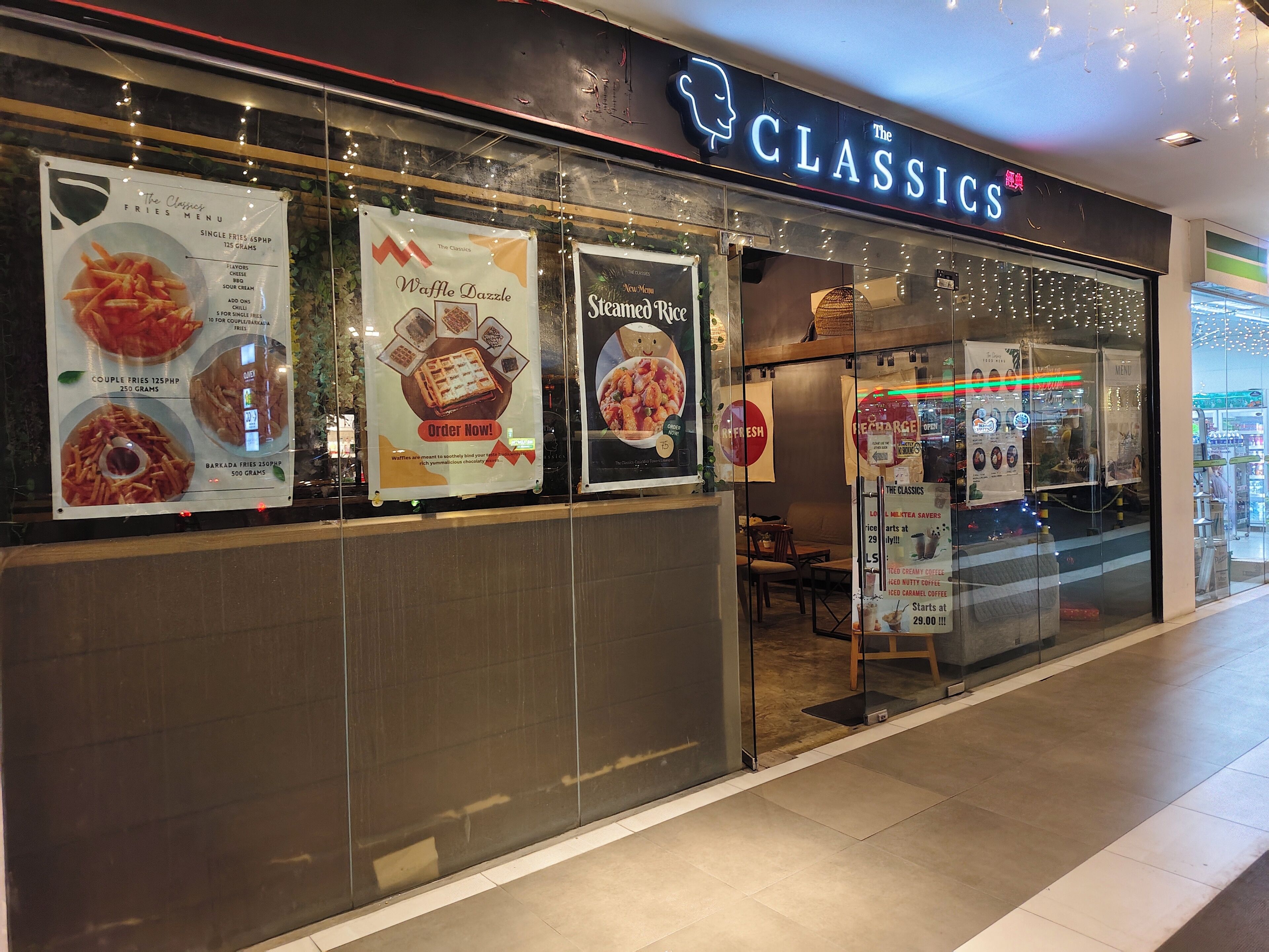A restaurant named 'The Classics' with a menu board advertising items like 'Waffle Dazzle' and 'Steamed Rice'.