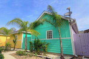 A house with a satellite dish, a window, and a door. - Spacious townhome with community pool! (Port Aransas)