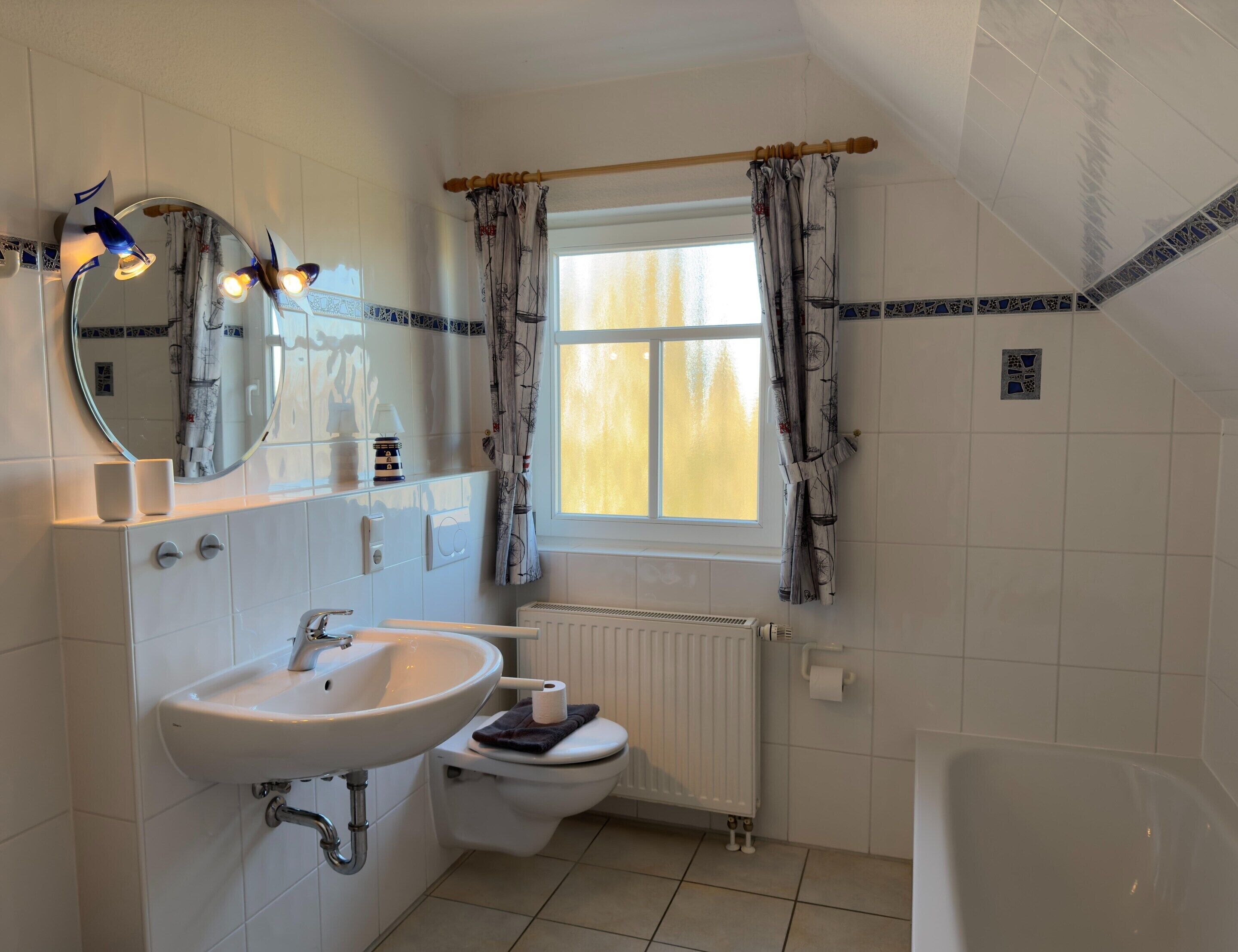 A bathroom with a sink, toilet, and bathtub.