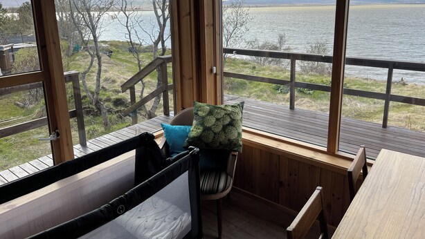 A cabin with a wooden deck, a cushioned bench, and a table. - Tranquil 4-bedrooms in two cottages Near Golden Circle-10 sleeps with WiFi, AC (Grímsnes- og Grafningshreppur)