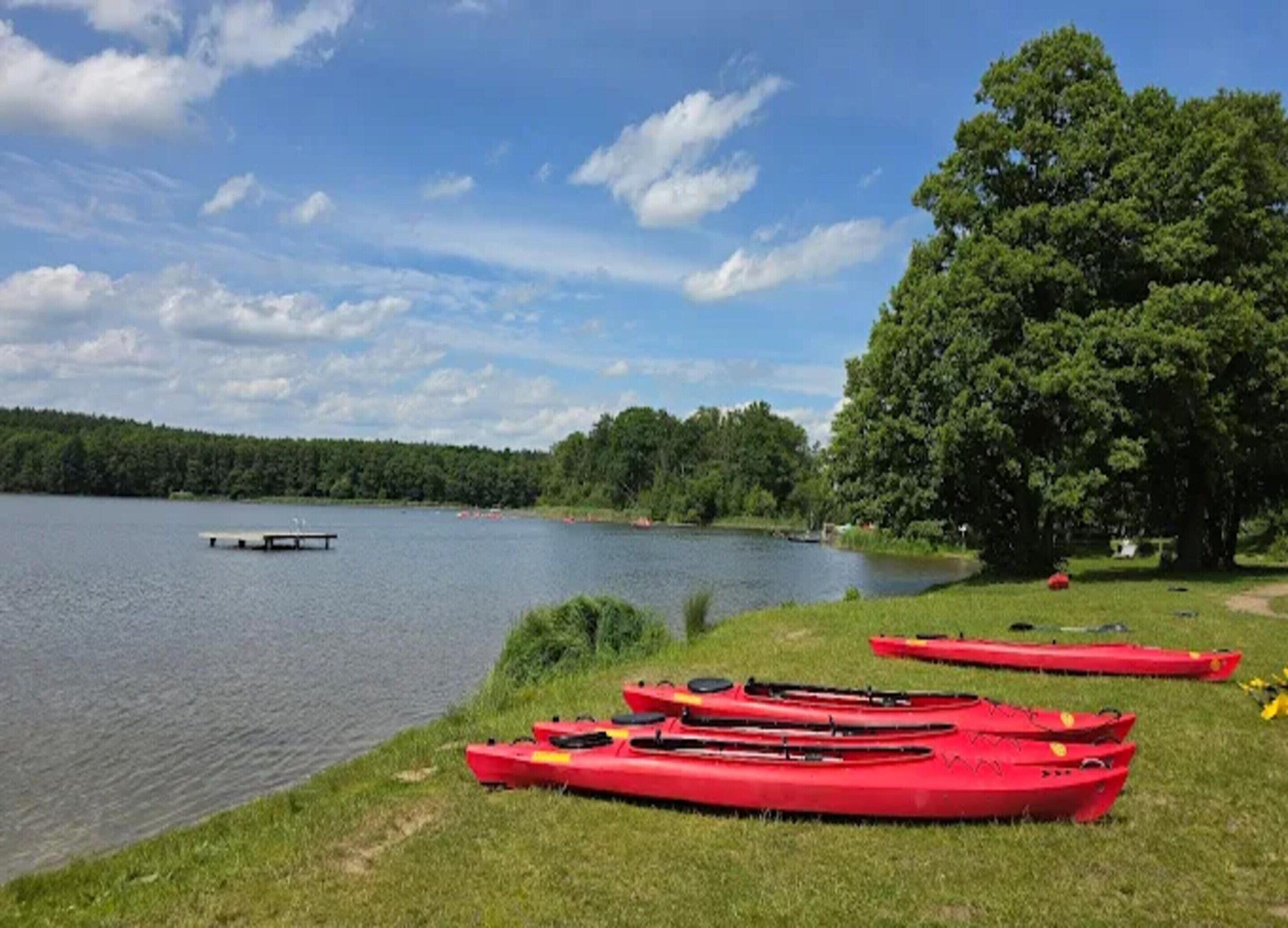Une vue sur le lac avec des kayaks et un quai.
