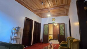 A hotel lobby with wooden ceiling, a reception desk, a small dog, and a red carpet. - Grand Bedir (Istanbul)