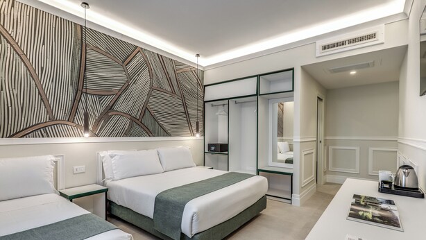 A modern hotel room with two beds, a desk with a coffee maker, and a large abstract wall art piece. - Relais Marco Polo (Rome)