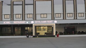 A hotel and restaurant with a modern facade, large windows, and a well-lit entrance.