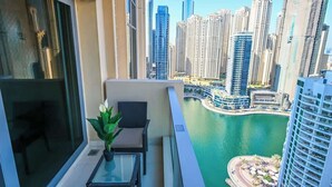 A balcony with a view of a cityscape and a body of water. - Luxury Marina 1-Bedroom - 5-star Hotel Amenities (Dubai)