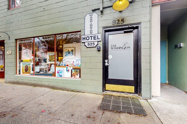 A hotel entrance with a sign reading "Washington 825 Hotel" and a door labeled "The Washington." - The Washington Hotel (Port Townsend)