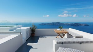A rooftop terrace with a wooden table and white cushioned seating, overlooking a scenic coastal view. - Ocean Caldera View Villa by Dalmyra Estate (Santorini)