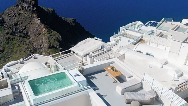 A rooftop terrace with a pool, seating area, and a view of the sea and islands. - Ocean Caldera View Villa by Dalmyra Estate (Santorini)