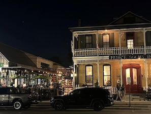 A two-story building with a balcony, a sign reading 'Prince Solms Inn,' and a street view with cars and people.