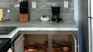 A kitchen with wooden cabinets, a marble countertop, and a built-in oven. - 516 - House in West Yellowstone (West Yellowstone)