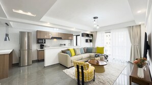 A modern apartment with a kitchen, living area, and dining space. - Winchester Garden (Nairobi)