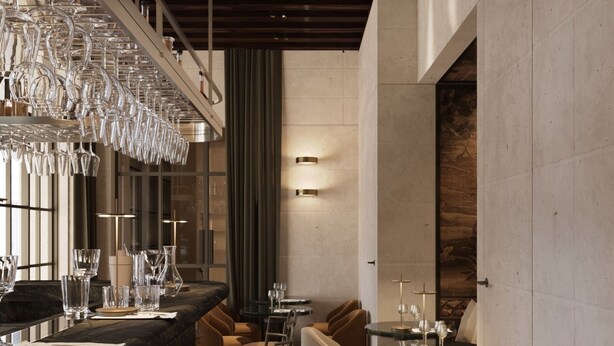 Un espace bar moderne avec un long comptoir, de nombreux tabourets et un luminaire suspendu.