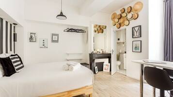 Relax in a spacious bedroom with a large bed, desk area, and stylish artwork.