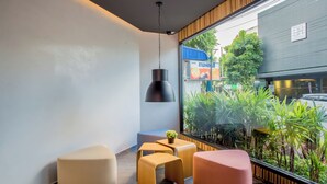 A modern interior with a large window, a hanging pendant light, and a small table with a plant. - Thai me up the Tower (Chalong)
