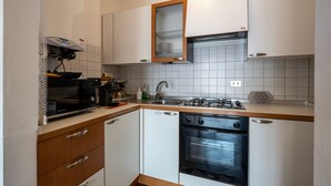 A compact kitchen with a built-in oven, a dishwasher, and a gas stove. - Apartment with garage near the center of Verona (Verona)