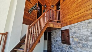 A wooden staircase with a stone wall and a wooden ceiling. - [Cogne - Gran Paradiso] Chalet La Grivola (Gimillan)