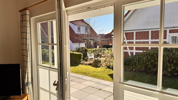 A room with a sliding glass door leading to a patio.