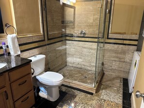 Shower, hair dryer, towels, toilet paper