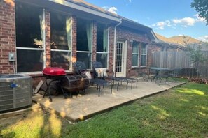 A house with a patio, outdoor furniture, and a grill. - Dream Dust Drive When East Meets West (North Richland Hills)