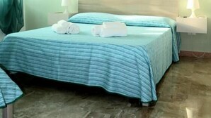 A hotel room with a bed, two bedside tables with lamps, a headboard, and a window with curtains. - Acquamarina B&B Deluxe (Cariati)
