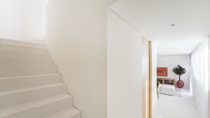 A modern interior with a staircase leading to a living area. - GuestReady - DPV GuestHouse - Apart 6 (Porto)