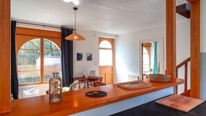 A kitchen with a wooden countertop, a hanging light fixture, and a view of the outdoors. - Ti an dour, entre terre et mer (Crac'h)