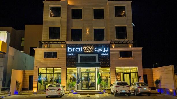A hotel with a modern facade, large windows, and a welcoming entrance with a glass door. - BRAI HOTEL (Al Duwadimi)
